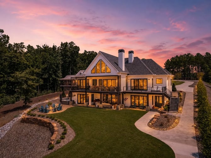 Lakefront home at dusk with fire pit and dock